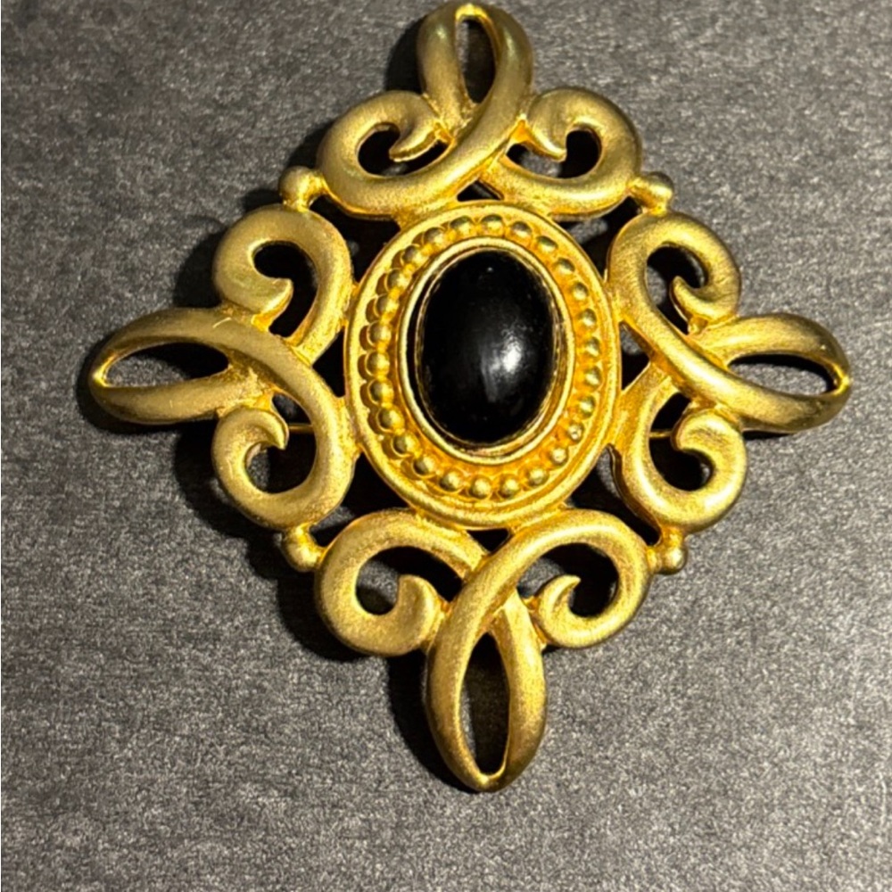 Elegant Gold and Black Brooch